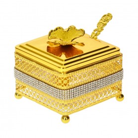 Glass sugar bowl with a diamond-shaped metal holder and a spoon