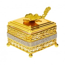 Glass sugar bowl with a diamond-shaped metal holder and a spoon