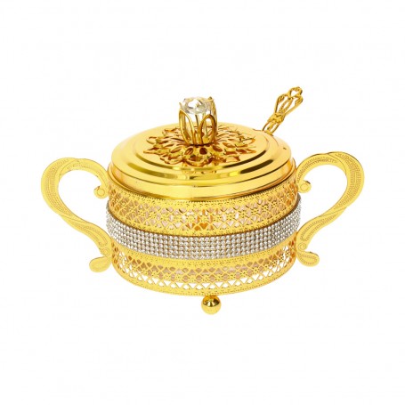 Glass sugar bowl with a diamond-shaped metal holder and a spoon