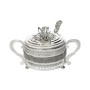 Glass sugar bowl with a diamond-shaped metal holder and a spoon