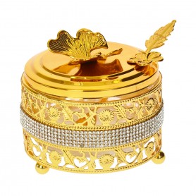 Glass sugar bowl with a diamond-shaped metal holder and a spoon