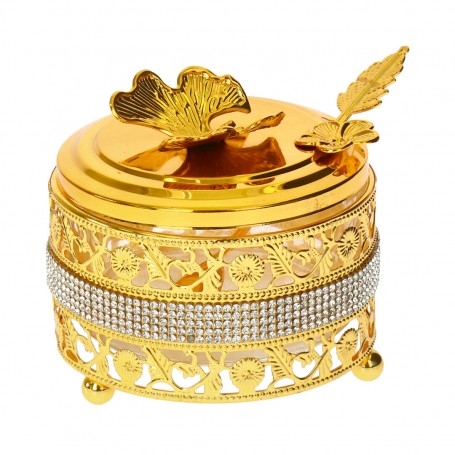 Glass sugar bowl with a diamond-shaped metal holder and a spoon