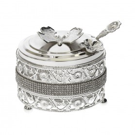 Glass sugar bowl with a diamond-shaped metal holder and a spoon